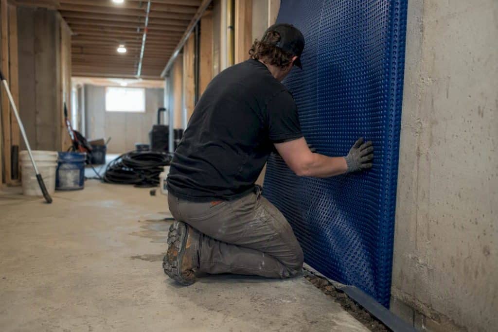 Installing basement cavity drain membrane and sump pump