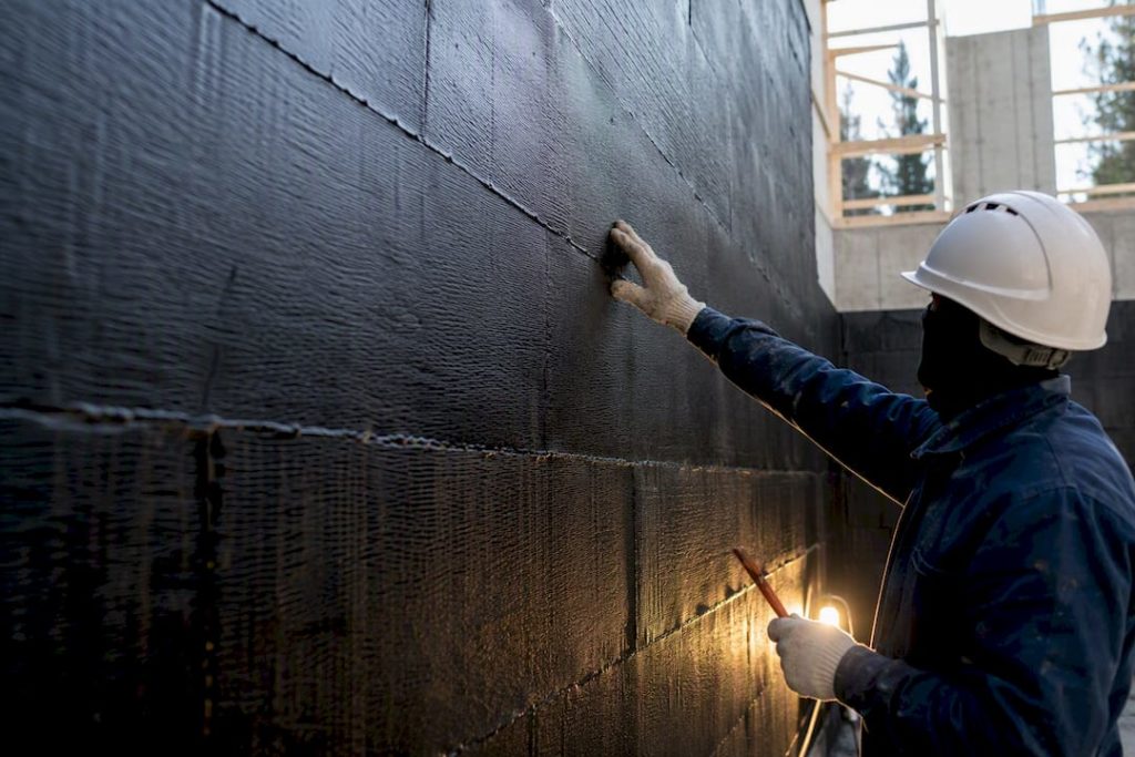 Inspector checking bituminous membrane laps