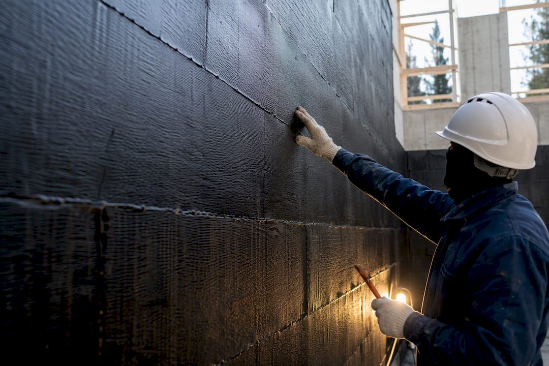 Inspector checking bituminous membrane laps