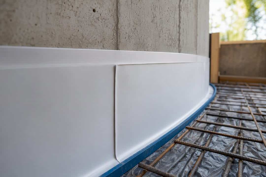 Bonded membrane against concrete wall
