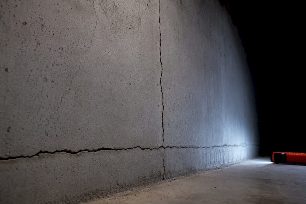 Concrete basement wall showing different crack patterns