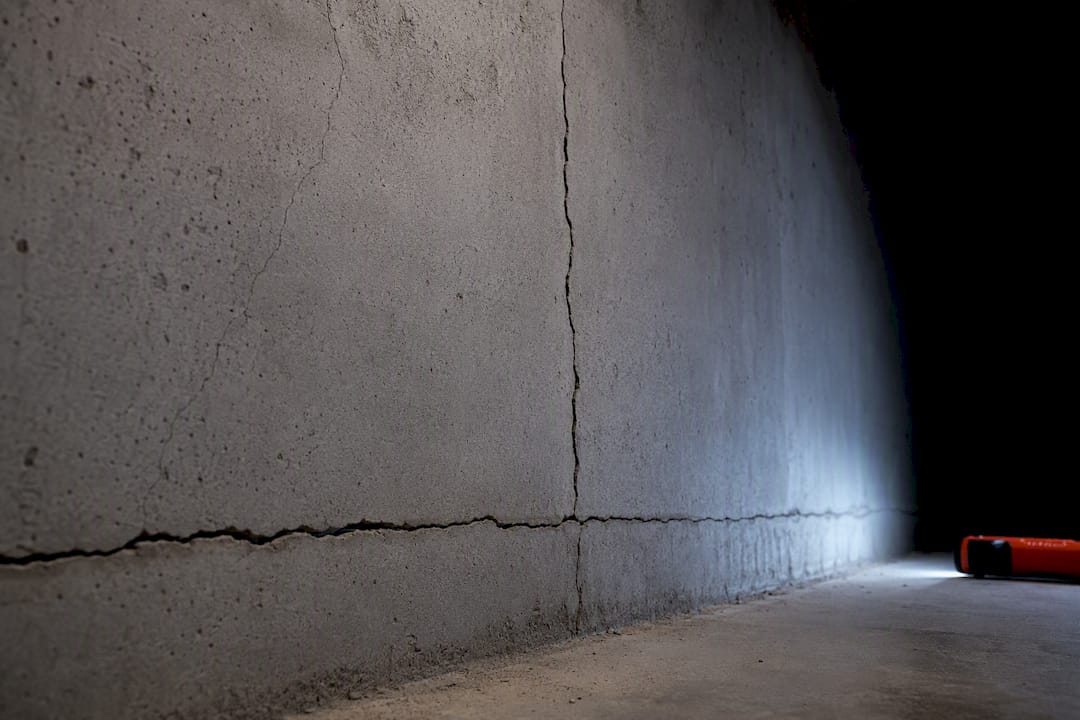 Concrete basement wall showing different crack patterns